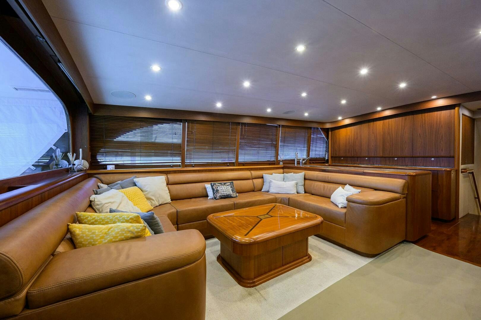 a living room with a couch and a table aboard BUSINESS STINKS Yacht for Sale