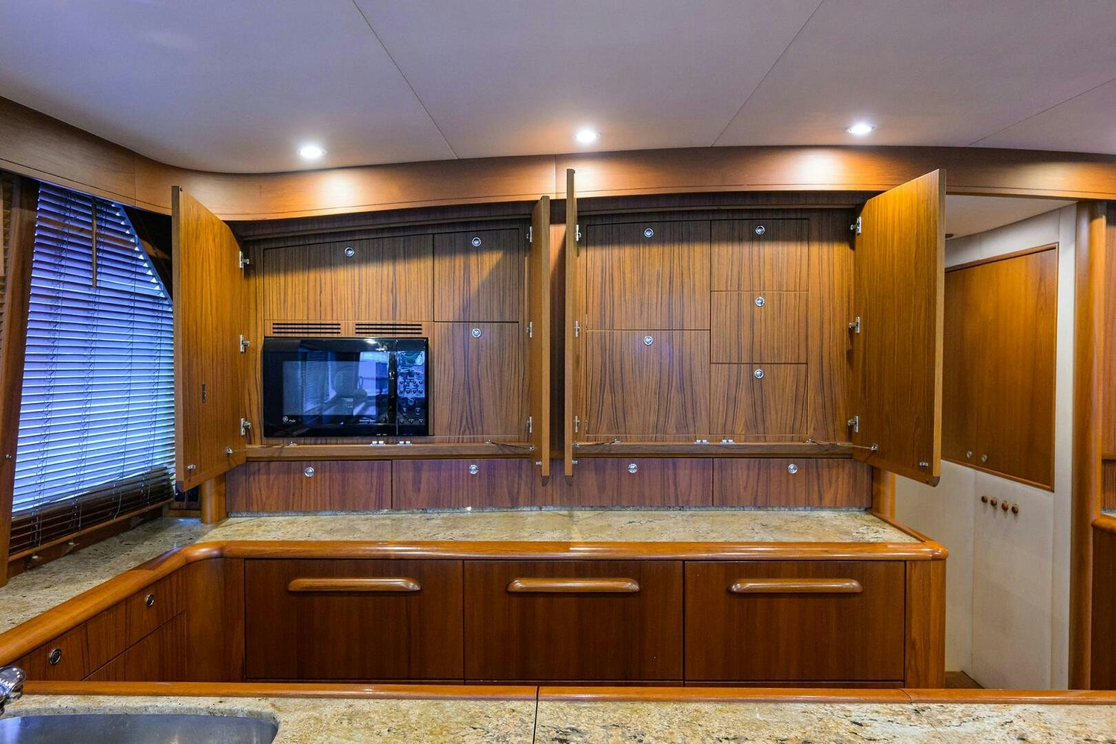 a kitchen with wooden cabinets aboard BUSINESS STINKS Yacht for Sale