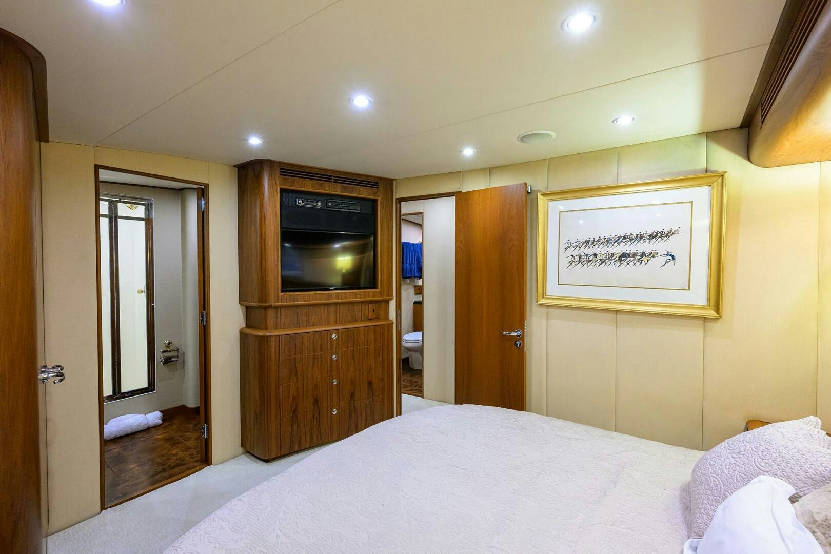 a hotel room with a bed and tv aboard BUSINESS STINKS Yacht for Sale