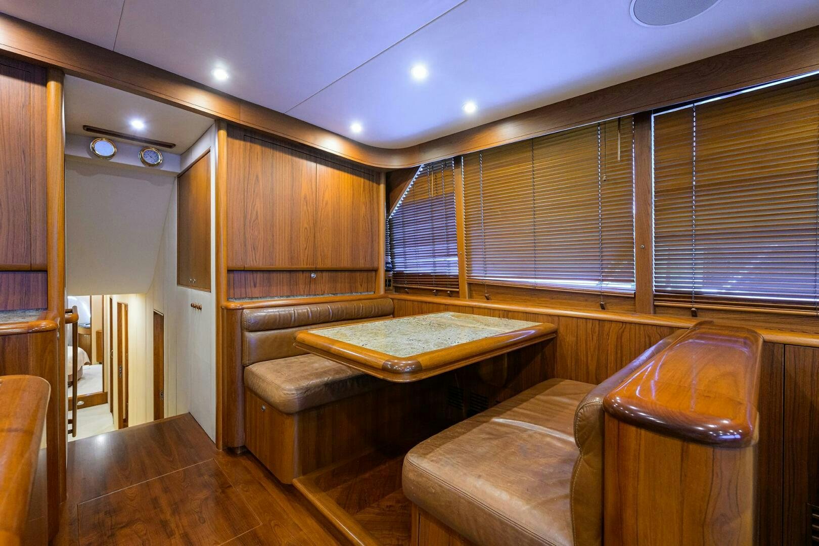 a room with a couch and a table aboard BUSINESS STINKS Yacht for Sale