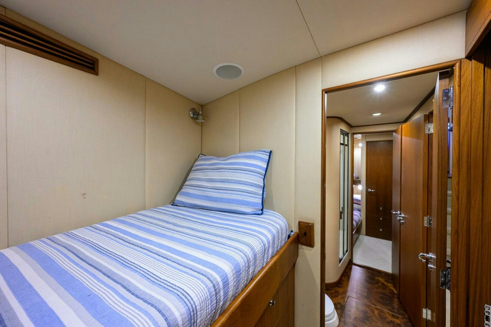 a bedroom with a bed and closet aboard BUSINESS STINKS Yacht for Sale
