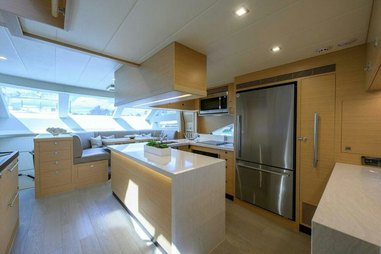 a kitchen with a refrigerator and cabinets aboard JOURNEY Yacht for Sale