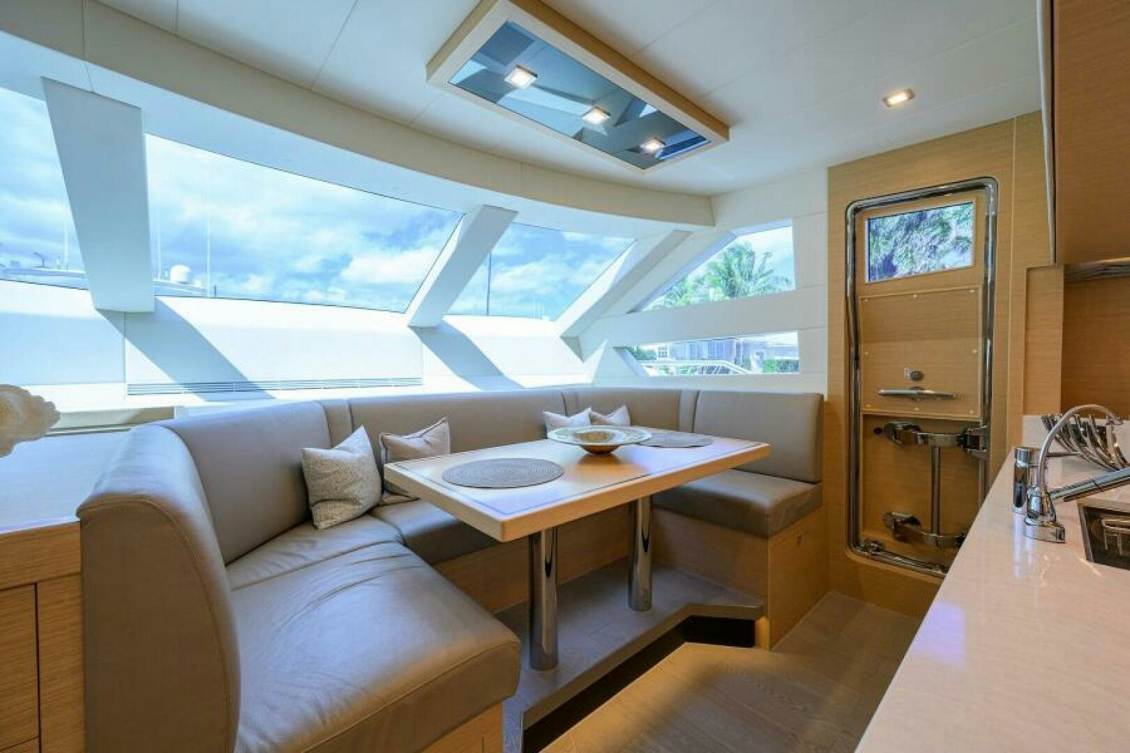 a living room with a couch and a table aboard JOURNEY Yacht for Sale