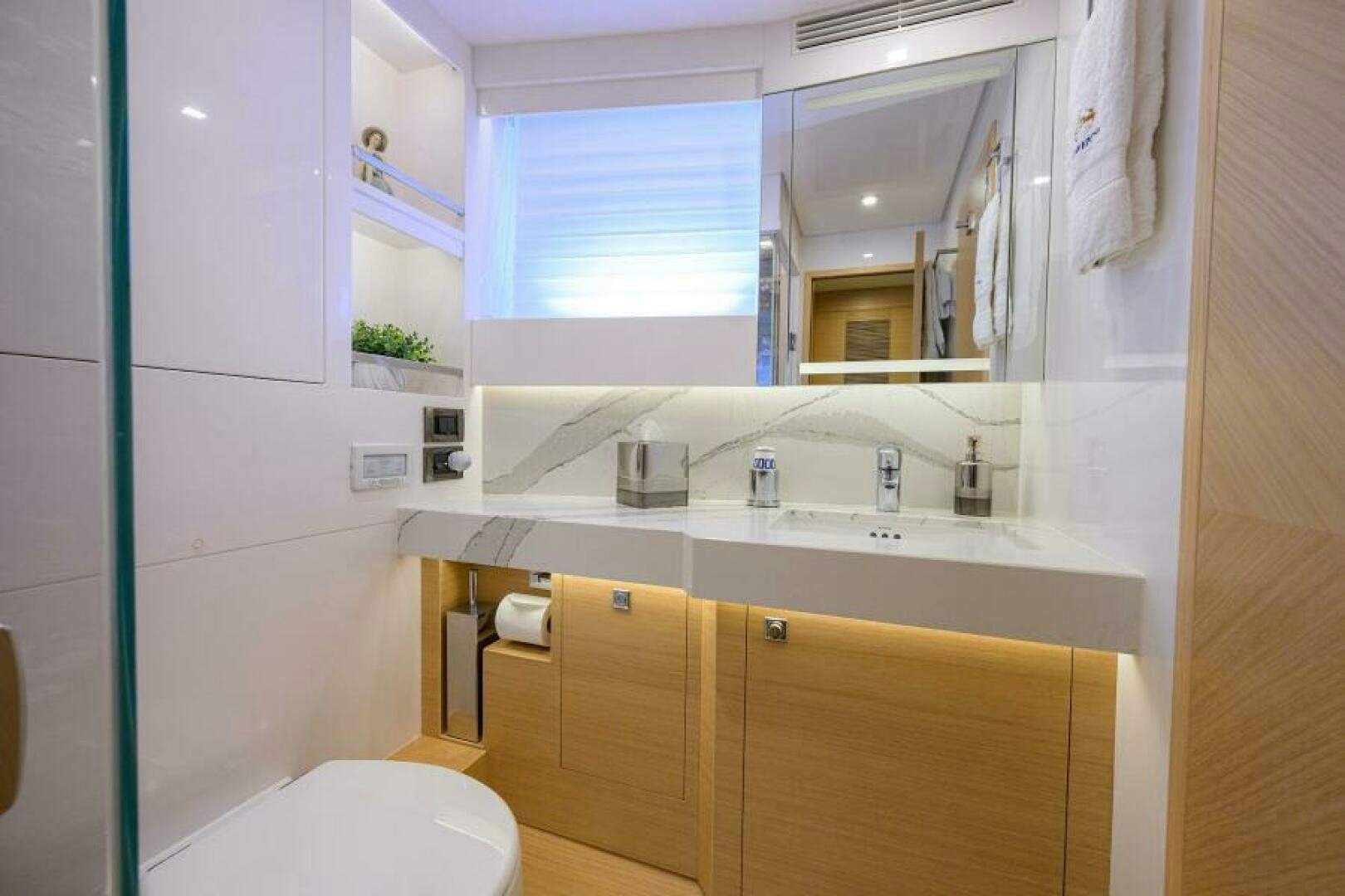 a bathroom with a sink and a toilet aboard JOURNEY Yacht for Sale