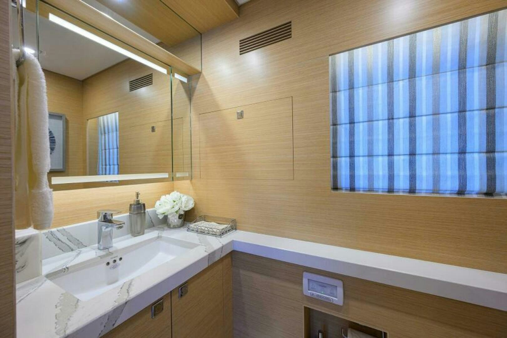 a bathroom with a large mirror aboard JOURNEY Yacht for Sale