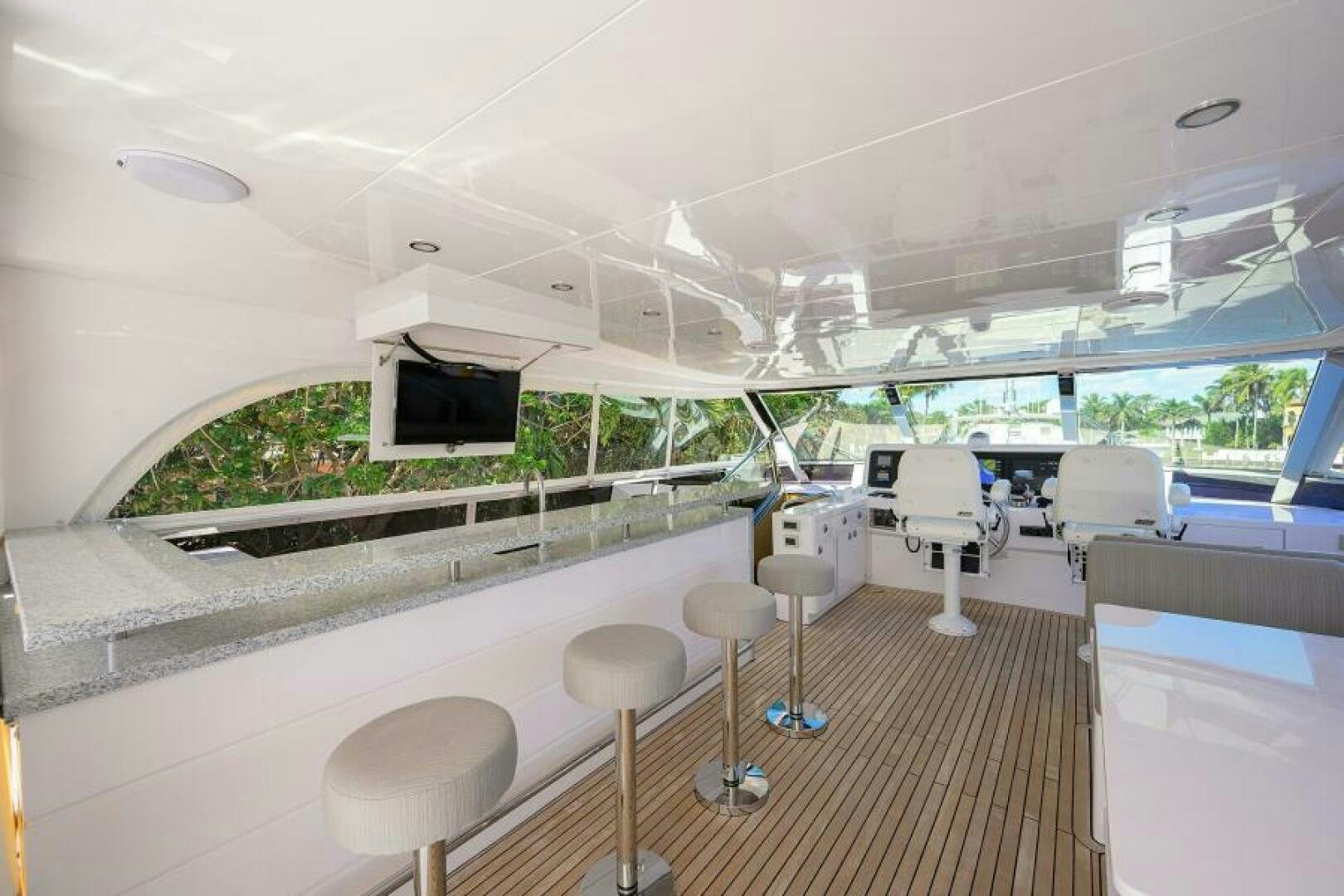 a room with a large window and a table with chairs and a computer aboard JOURNEY Yacht for Sale