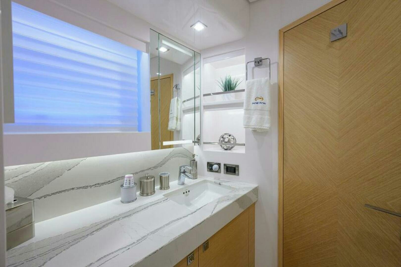 a bathroom with a sink and a mirror aboard JOURNEY Yacht for Sale
