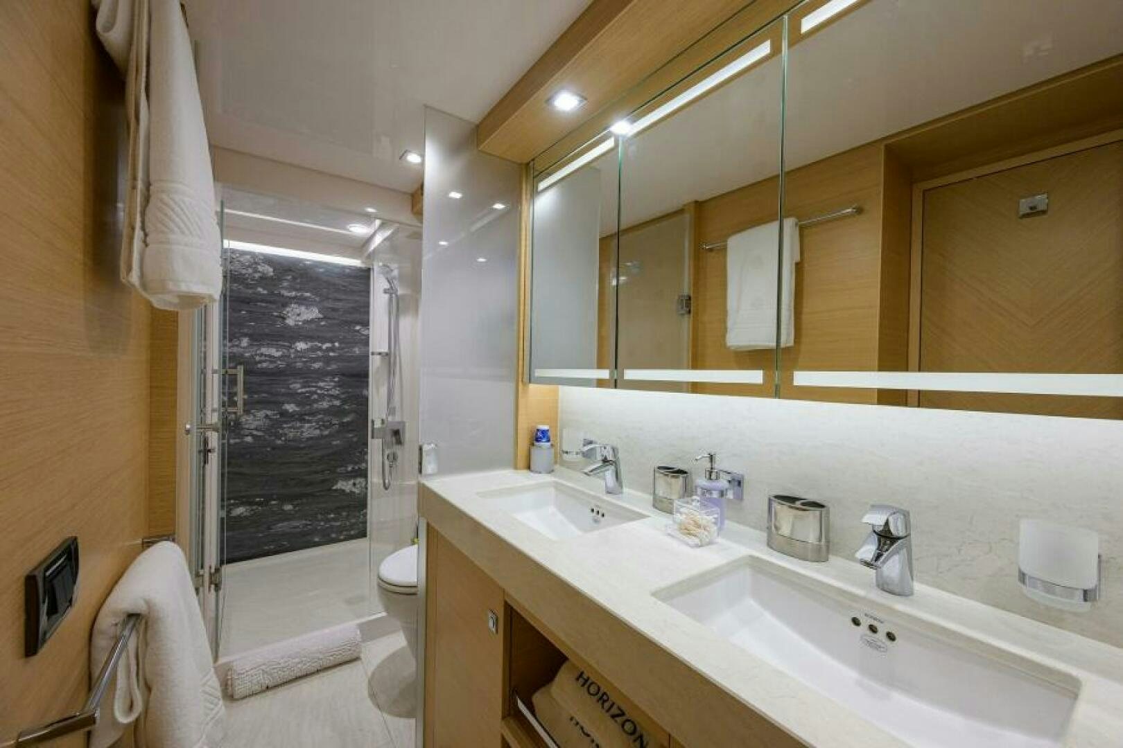 a bathroom with a large mirror aboard JOURNEY Yacht for Sale