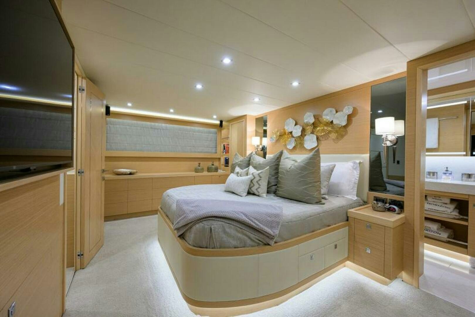 a bedroom with a bed and a mirror aboard JOURNEY Yacht for Sale