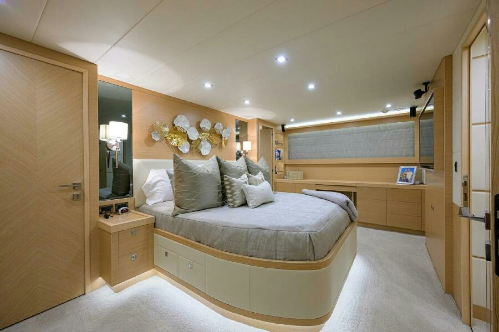 a bedroom with a bed and a desk aboard JOURNEY Yacht for Sale