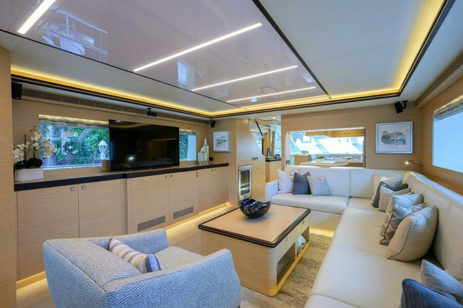 a living room with a couch and a television aboard JOURNEY Yacht for Sale