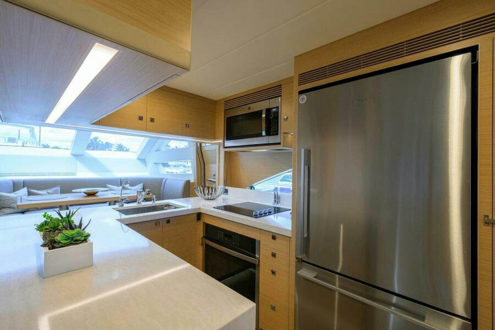 a kitchen with a large refrigerator aboard JOURNEY Yacht for Sale