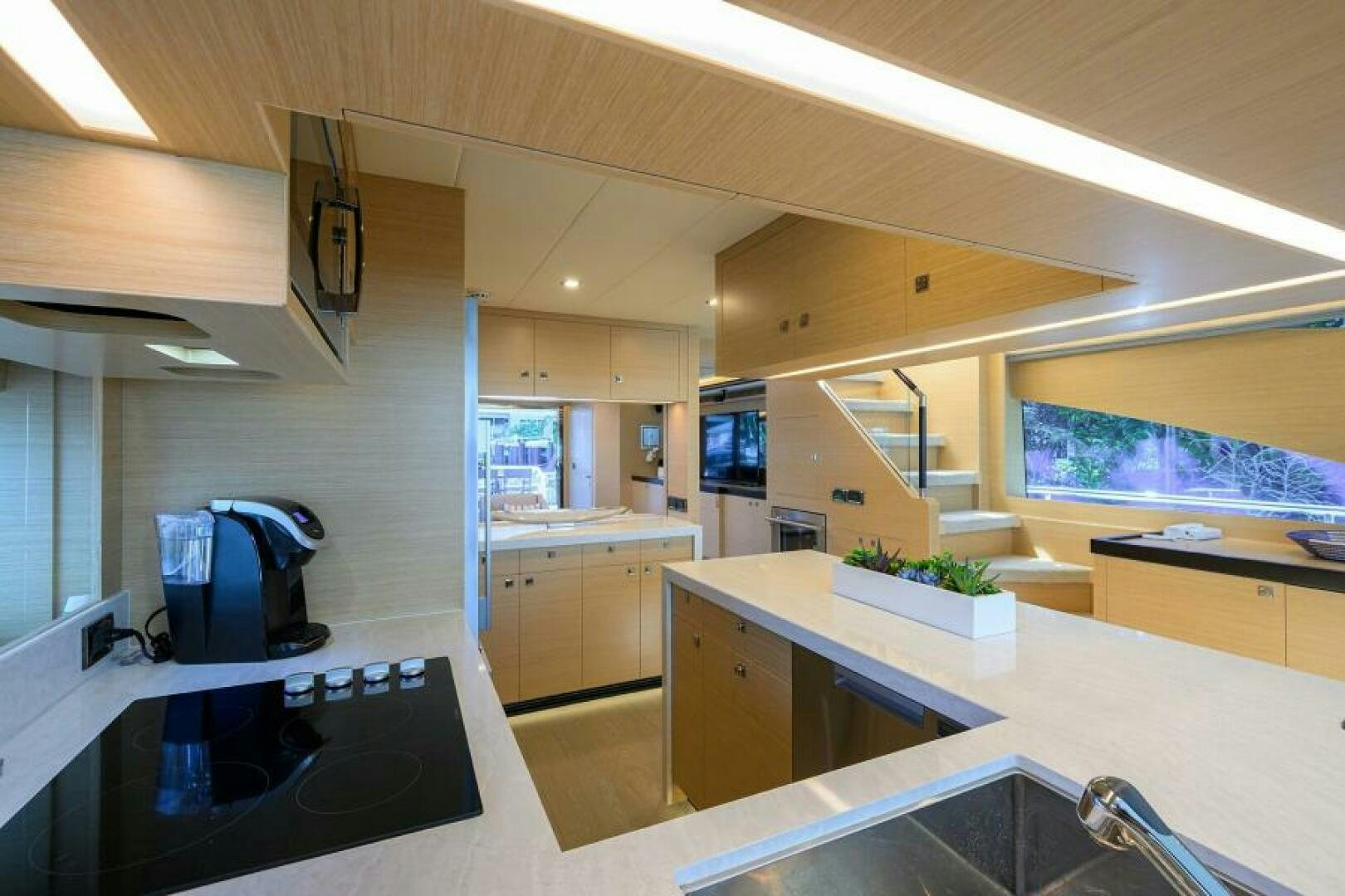 a kitchen with white cabinets aboard JOURNEY Yacht for Sale