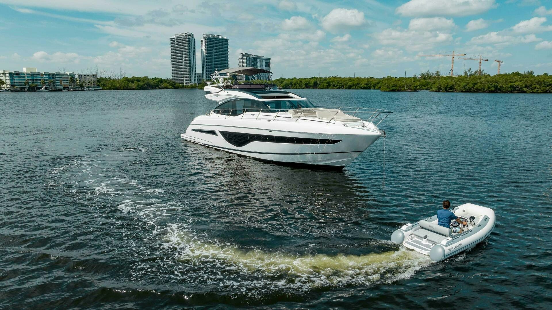 a person driving a boat on the water aboard BEST OF YOU Yacht for Sale