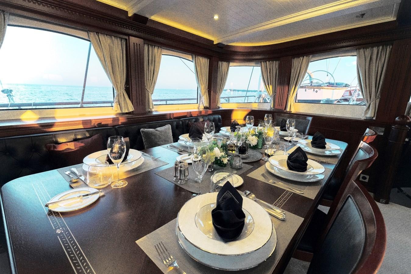 a table set with plates and glasses aboard MIKHAIL S. VORONTSOV Yacht for Sale