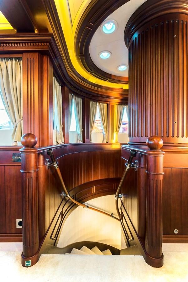 a wooden chair with a large wooden chair in a room with curtains aboard MIKHAIL S. VORONTSOV Yacht for Sale