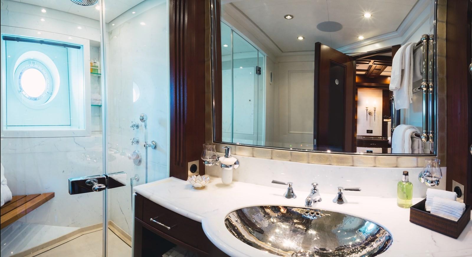 a bathroom with a large mirror aboard MIKHAIL S. VORONTSOV Yacht for Sale