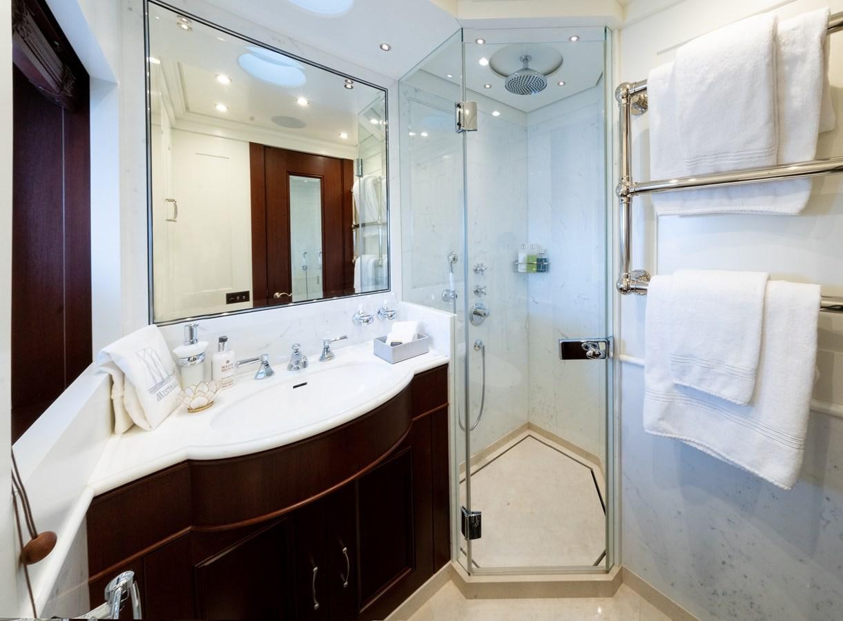 a bathroom with a sink and a mirror aboard MIKHAIL S. VORONTSOV Yacht for Sale