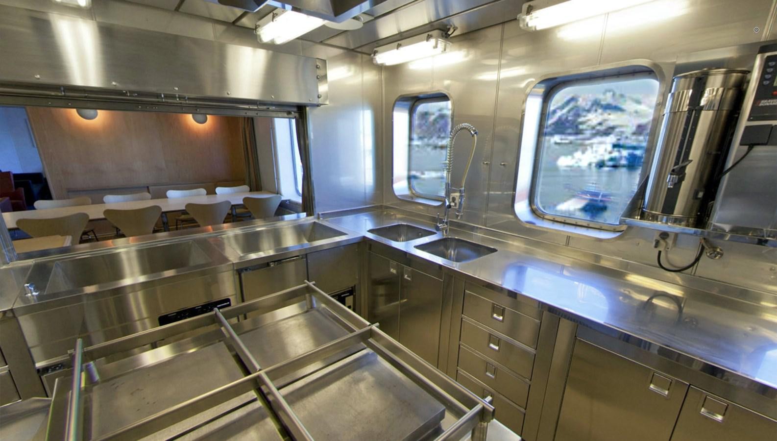 a kitchen with stainless steel appliances aboard OCEAN XPLORER 71 Yacht for Sale