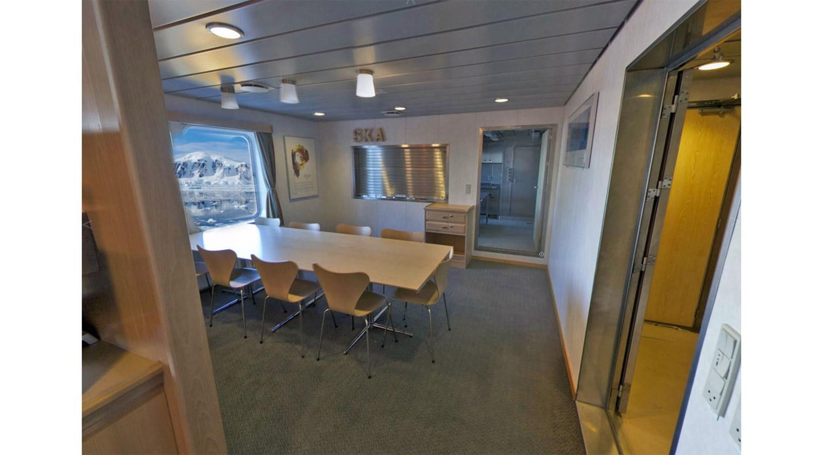 a hallway with tables and chairs aboard OCEAN XPLORER 71 Yacht for Sale