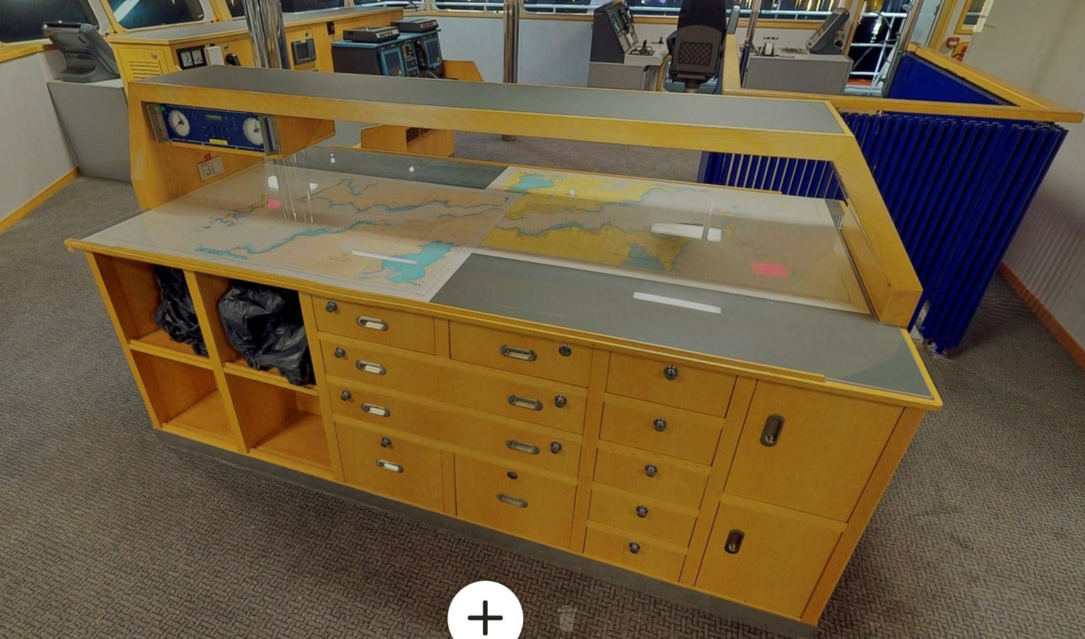 a desk with a chair and a computer on it aboard OCEAN XPLORER 71 Yacht for Sale