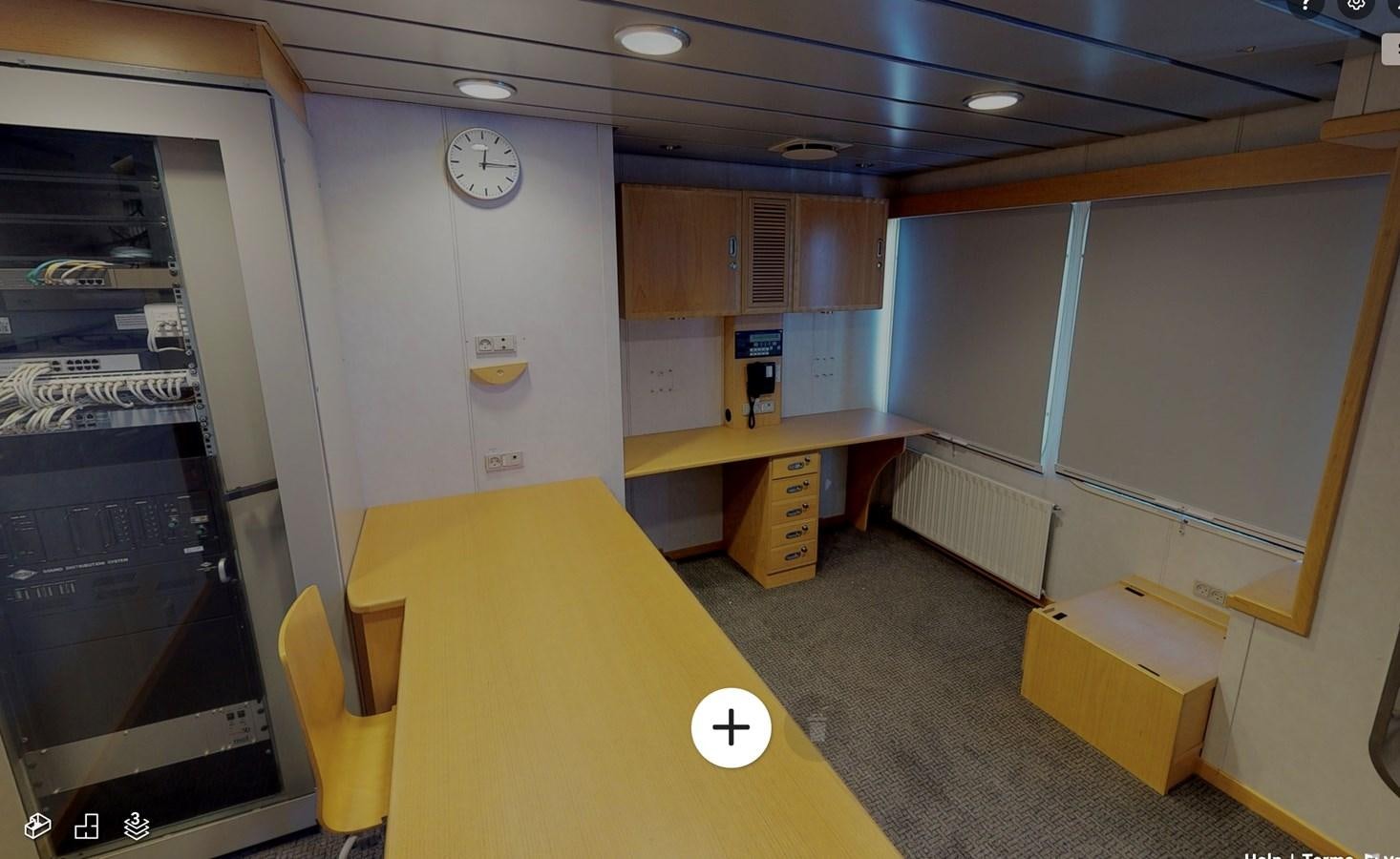 a room with a desk and a clock aboard OCEAN XPLORER 71 Yacht for Sale