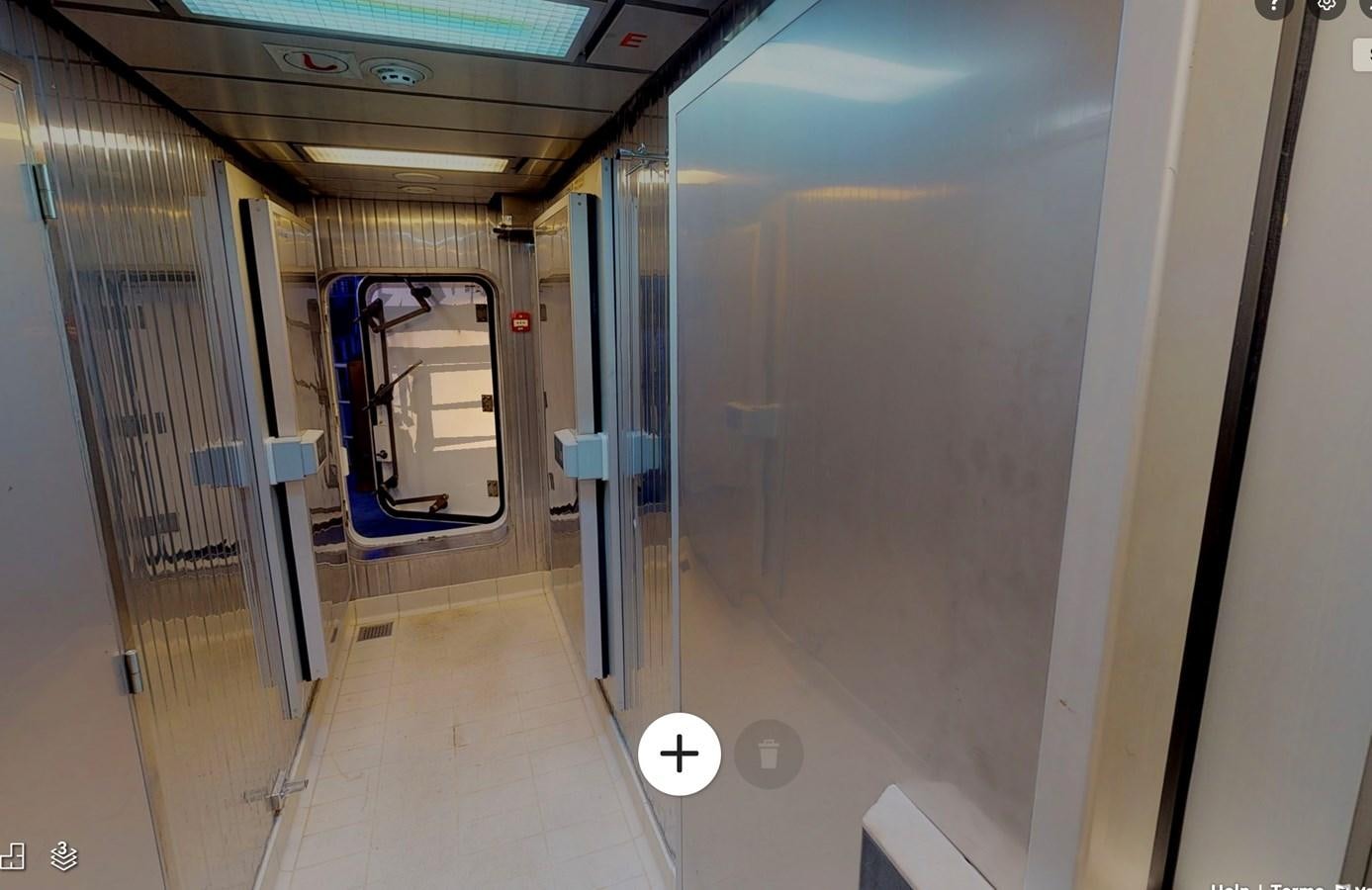 a hallway with a door and a window aboard OCEAN XPLORER 71 Yacht for Sale