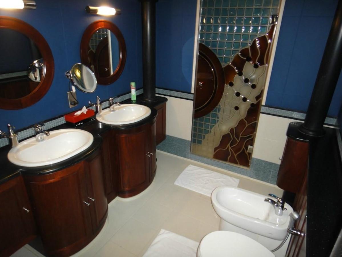 a bathroom with sinks and mirrors aboard WARSAN Yacht for Sale