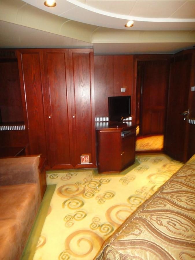 a room with a tv and a cabinet aboard WARSAN Yacht for Sale