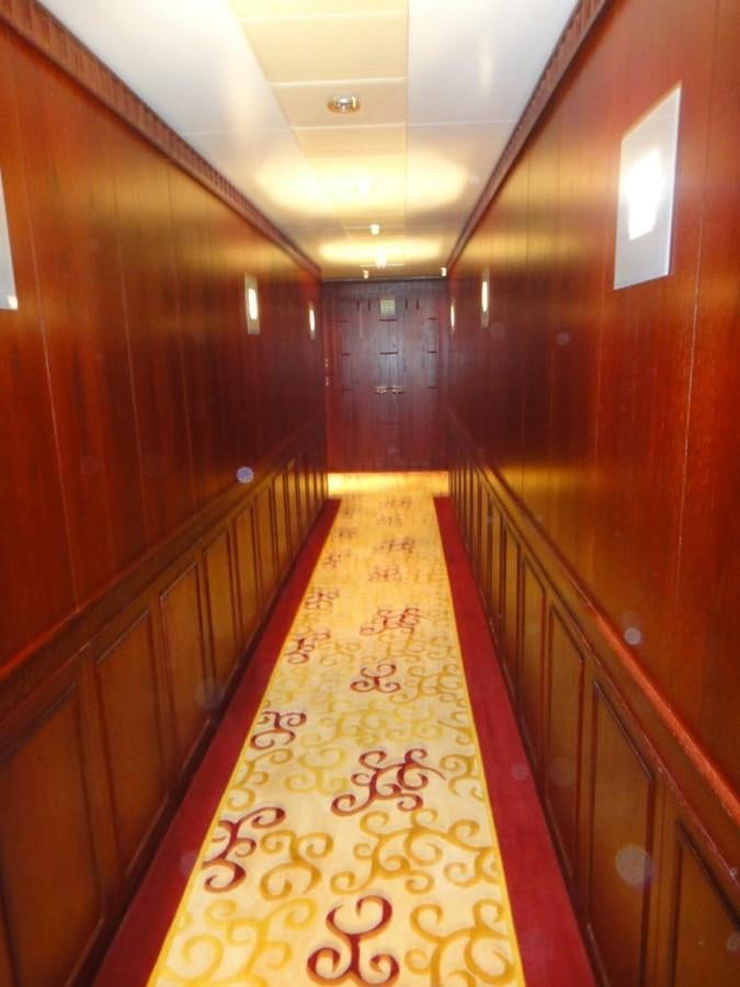 a hallway with wood walls aboard WARSAN Yacht for Sale