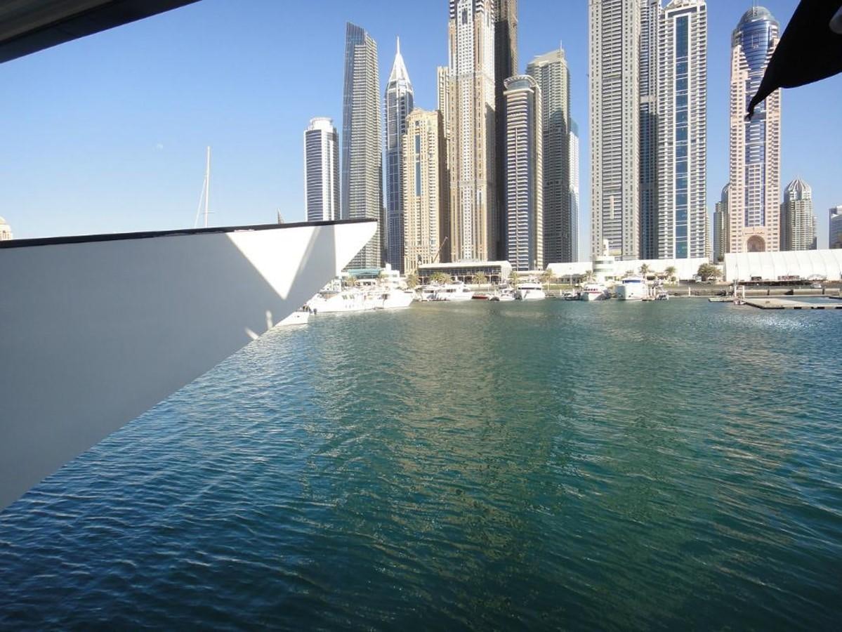 a body of water with buildings in the background aboard WARSAN Yacht for Sale