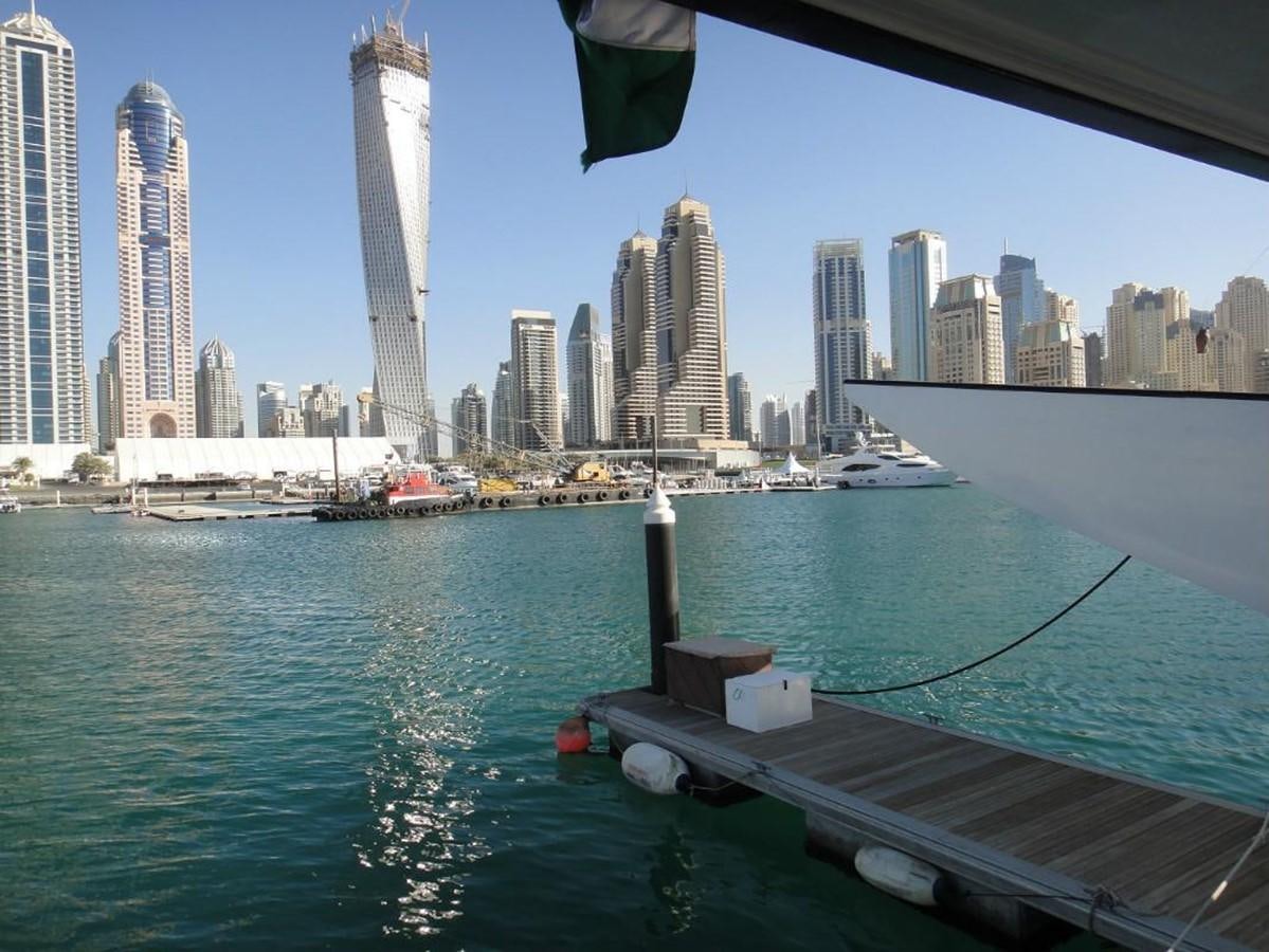 a body of water with boats and a city in the background aboard WARSAN Yacht for Sale