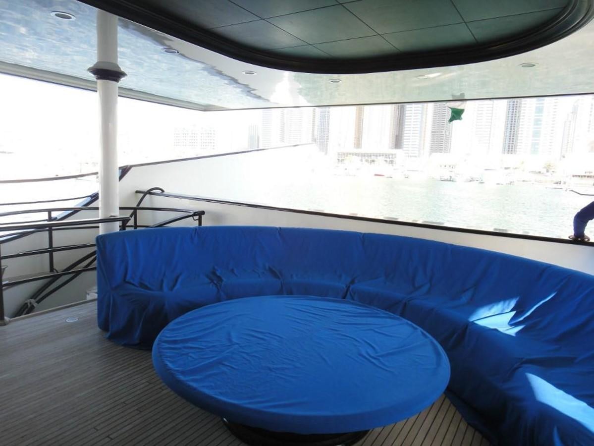 a pool with a table and chairs aboard WARSAN Yacht for Sale