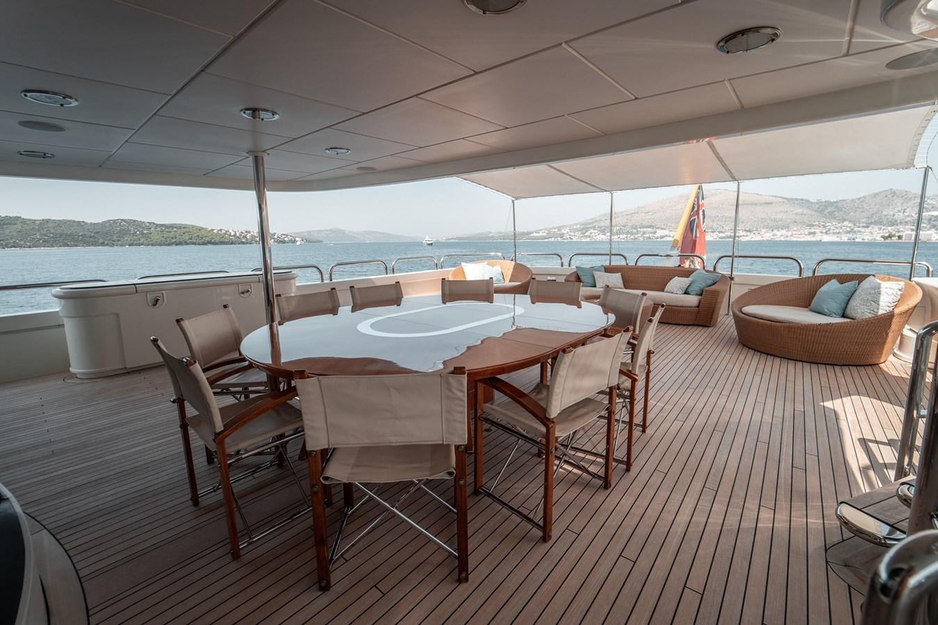 a table and chairs on a deck aboard MERCURY Yacht for Sale