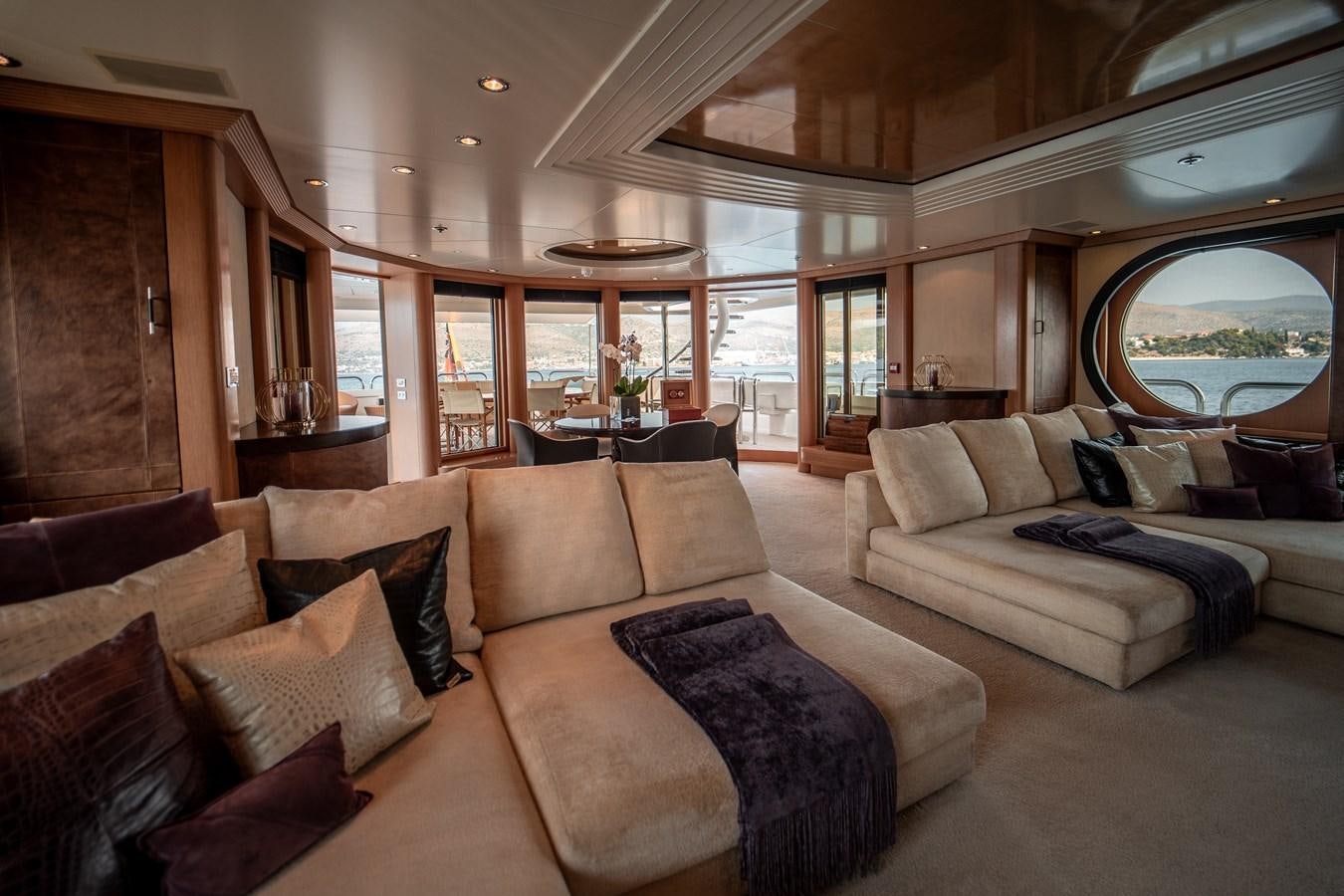 a living room with a couch and a large window aboard MERCURY Yacht for Sale