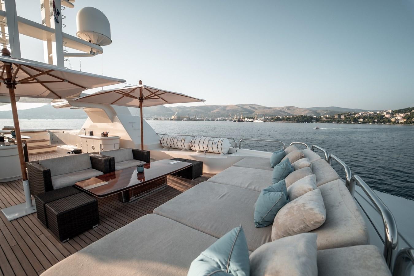 a large lounge area with a large body of water and a large umbrella aboard MERCURY Yacht for Sale