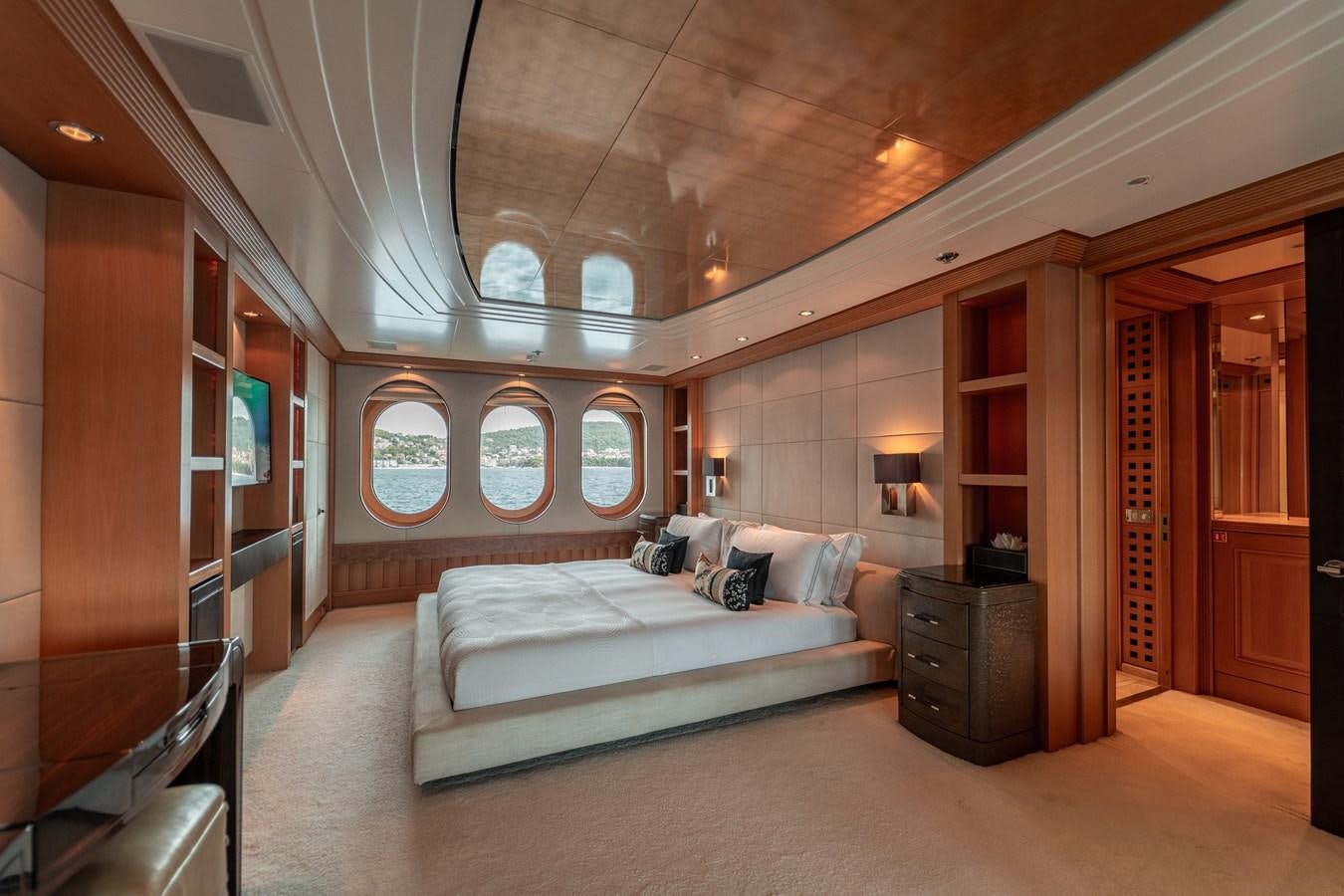 a large room with a bed and a large mirror aboard MERCURY Yacht for Sale