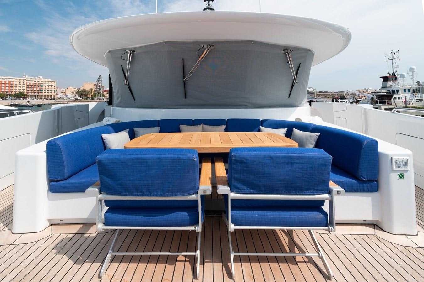 a table and chairs on a deck aboard UNDER CONTRACT!   SAINT  2012 ISA 500-2 POP @ Yacht for Sale