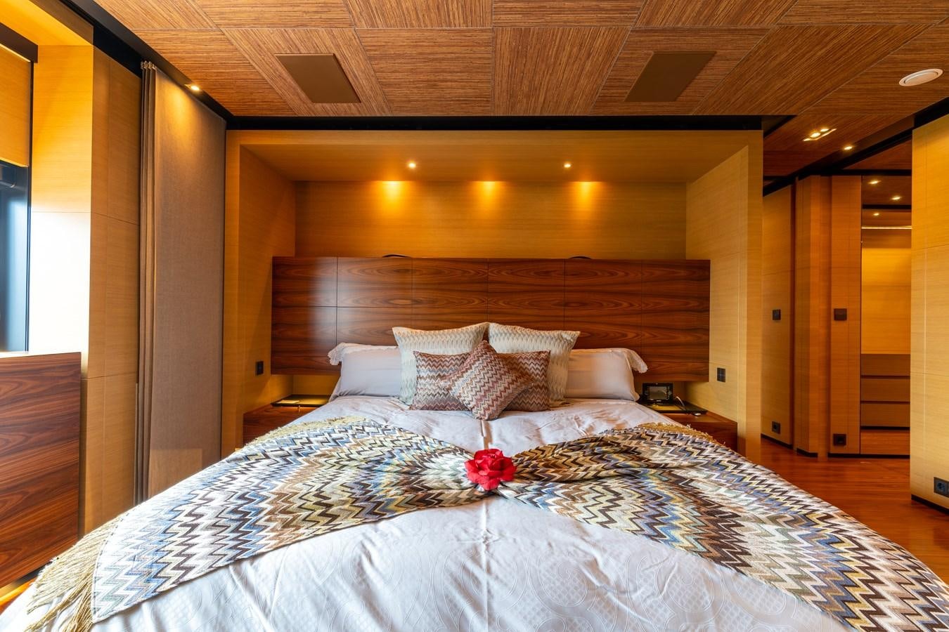 a bed with a flower on the bed aboard UNDER CONTRACT!   SAINT  2012 ISA 500-2 POP @ Yacht for Sale