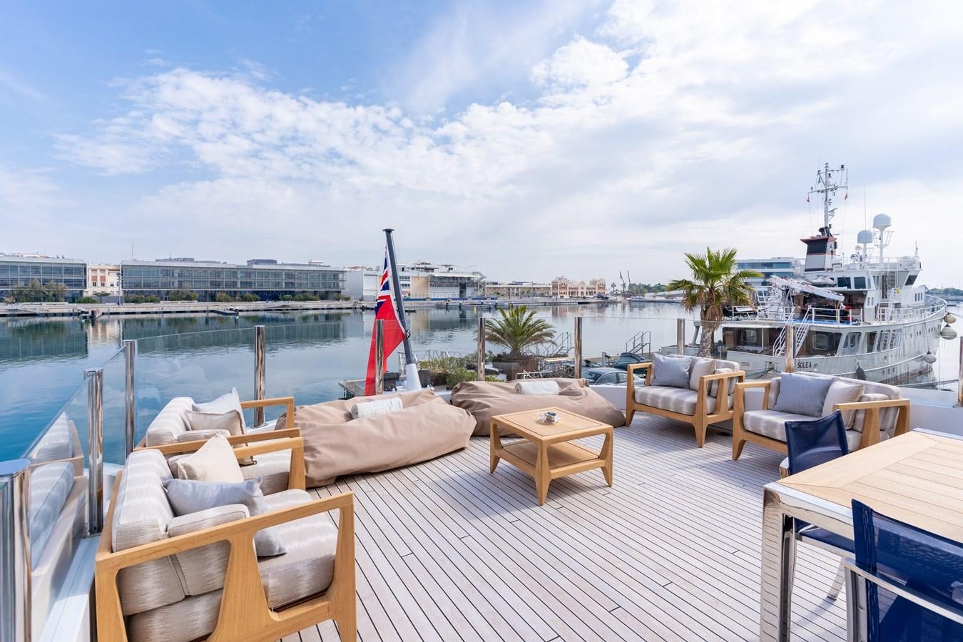 a deck with chairs and tables on it aboard UNDER CONTRACT!   SAINT  2012 ISA 500-2 POP @ Yacht for Sale