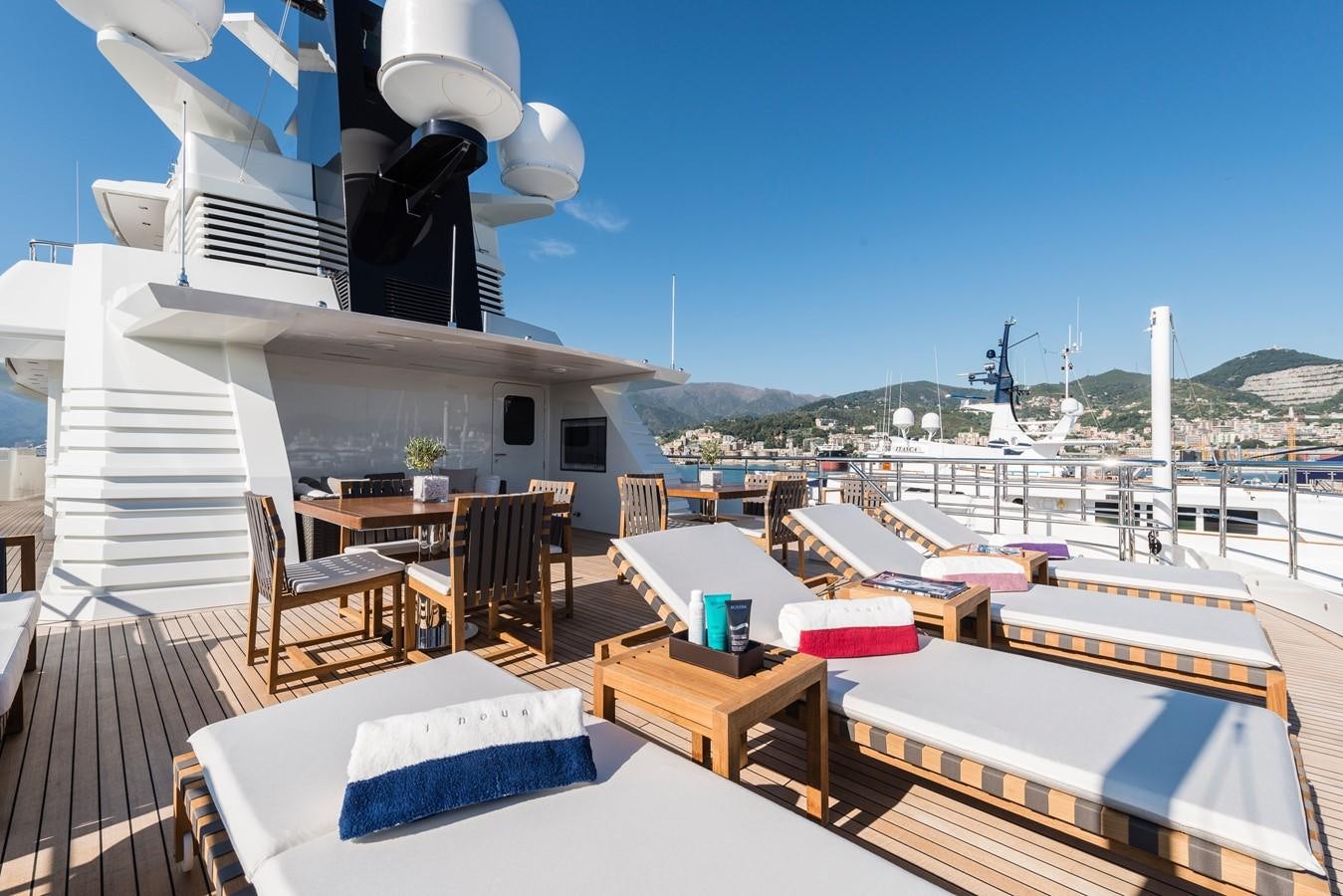 a deck with a table and chairs on it aboard I NOVA Yacht for Sale
