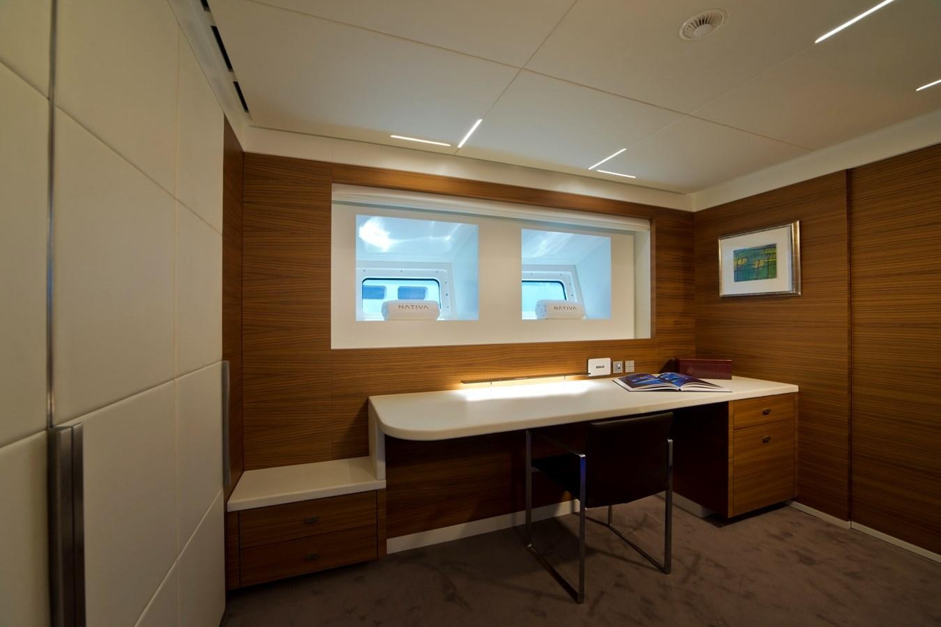 a room with a desk and a window aboard NATIVA Yacht for Sale