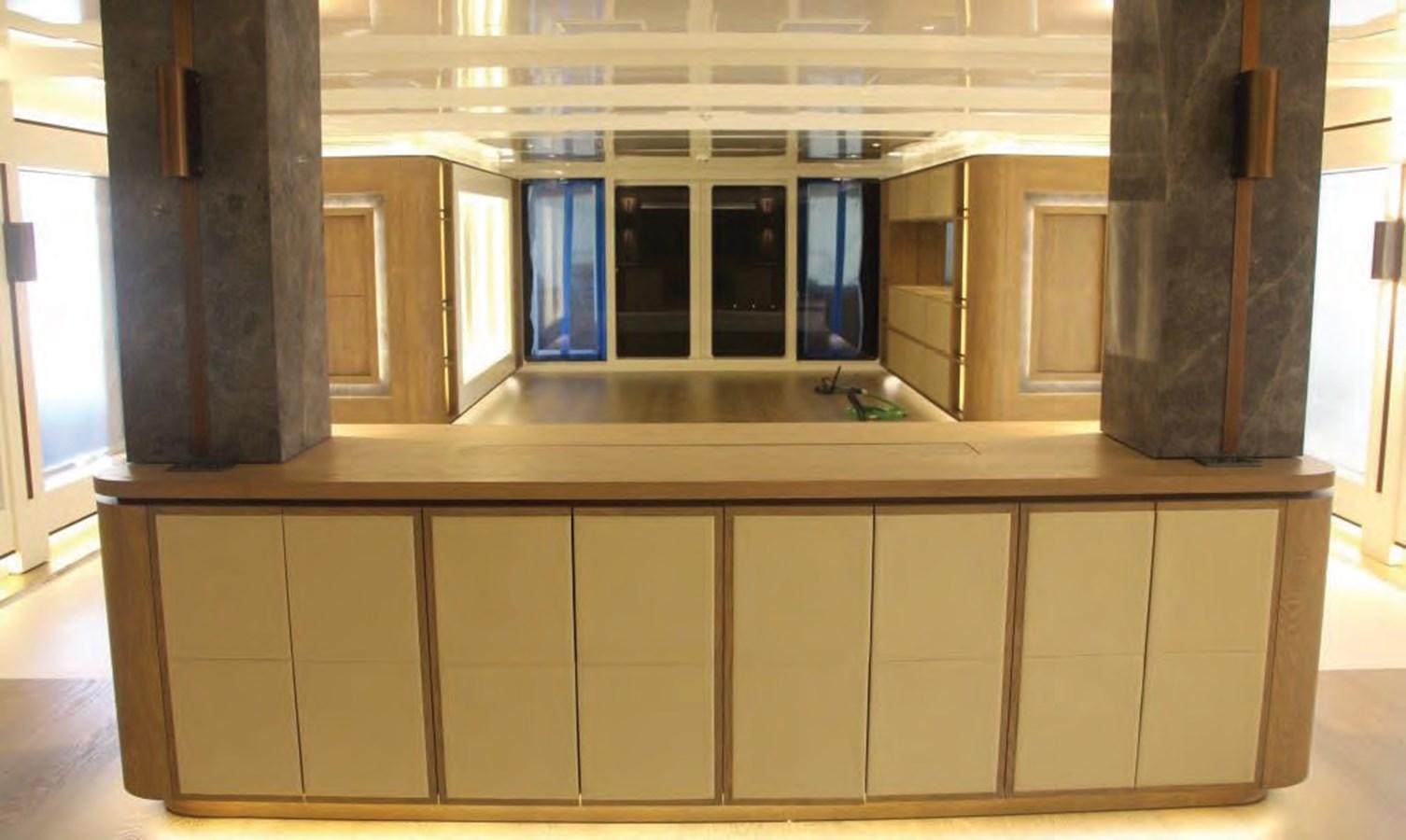 a room with cabinets and a table aboard HULL#05 Yacht for Sale