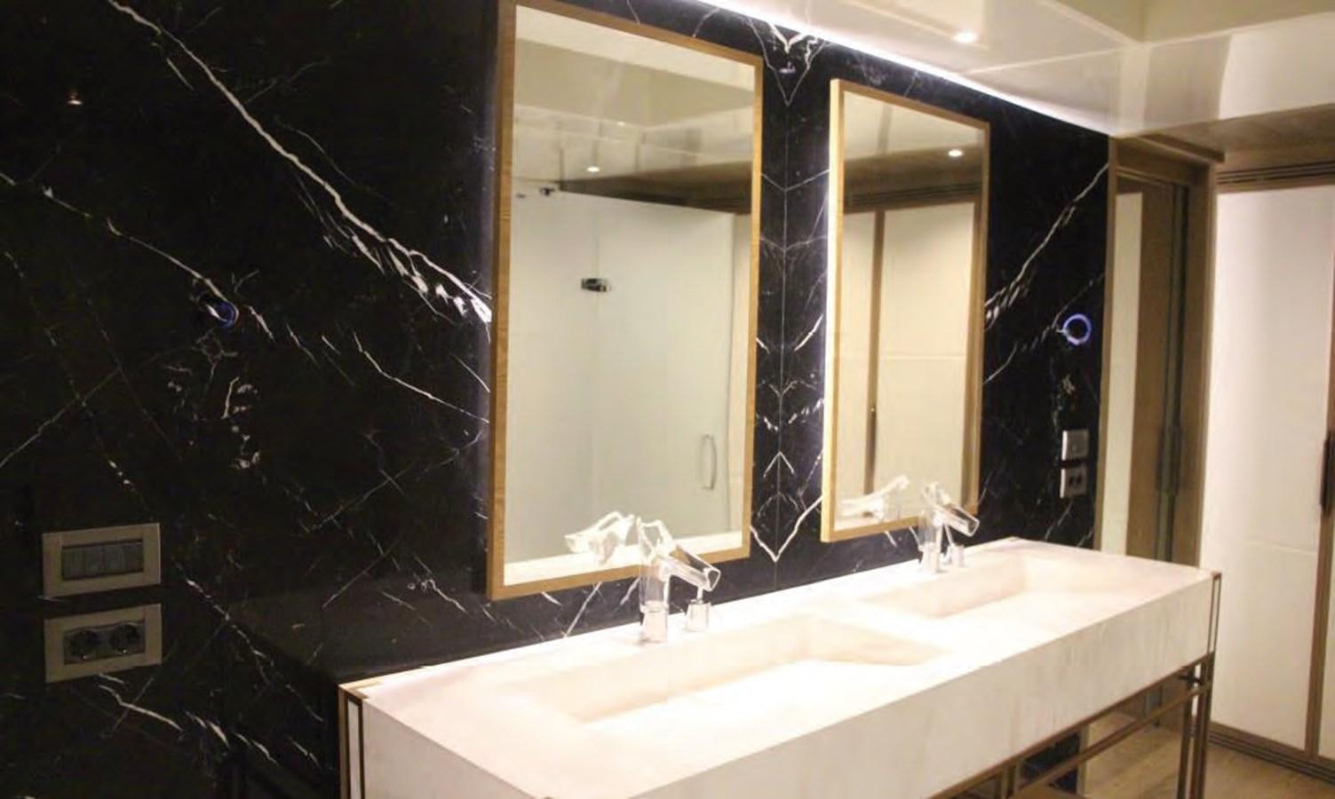 a bathroom with a sink and mirrors aboard HULL#05 Yacht for Sale