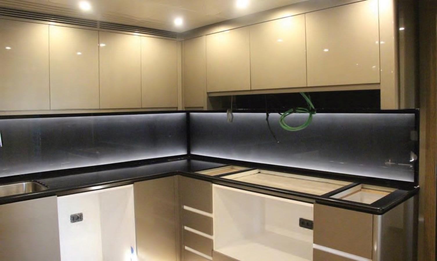 a kitchen with white cabinets aboard HULL#05 Yacht for Sale