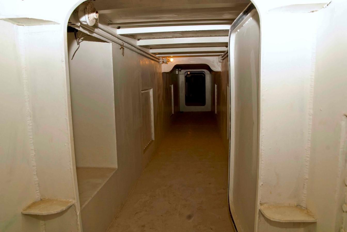 a hallway with a toilet and a trash can aboard PRINCIPE DEL MAR Yacht for Sale