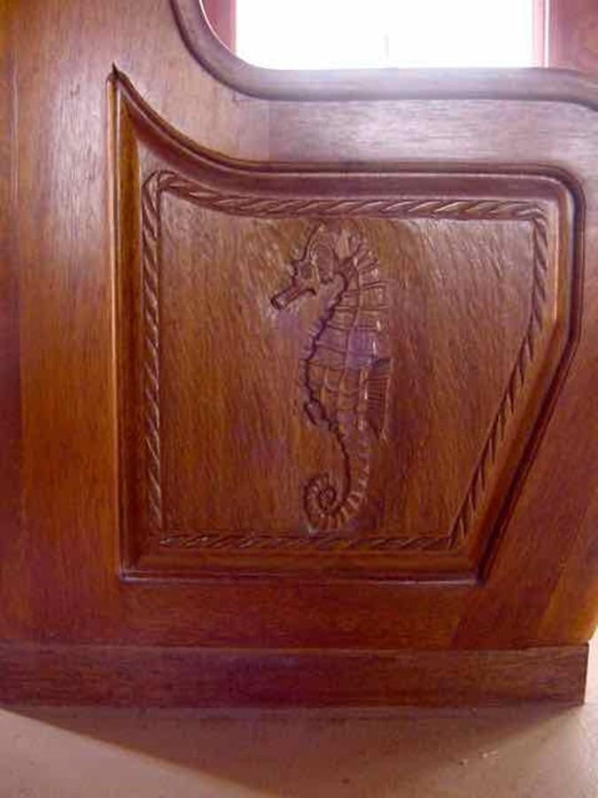 a wood cabinet with a drawing on it aboard PRINCIPE DEL MAR Yacht for Sale