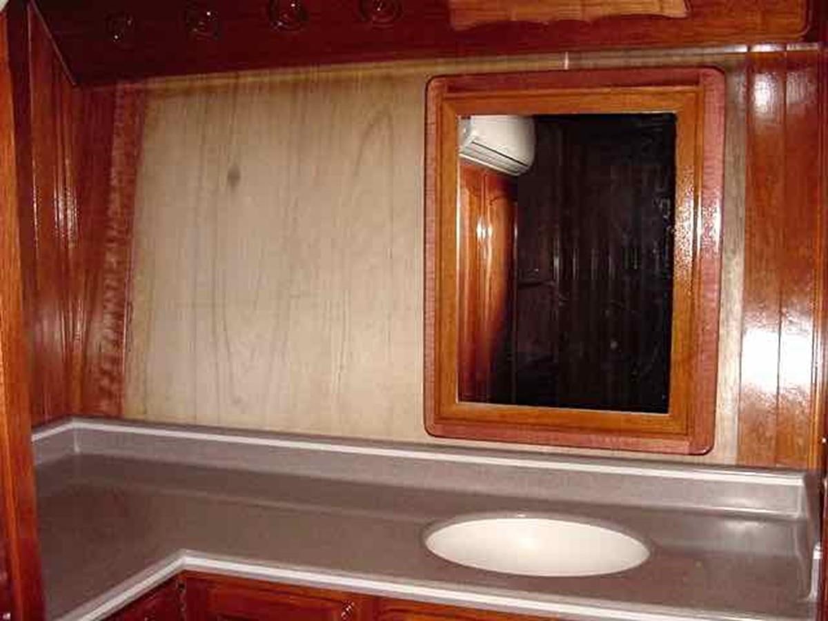 a bathroom with a sink and a mirror aboard PRINCIPE DEL MAR Yacht for Sale
