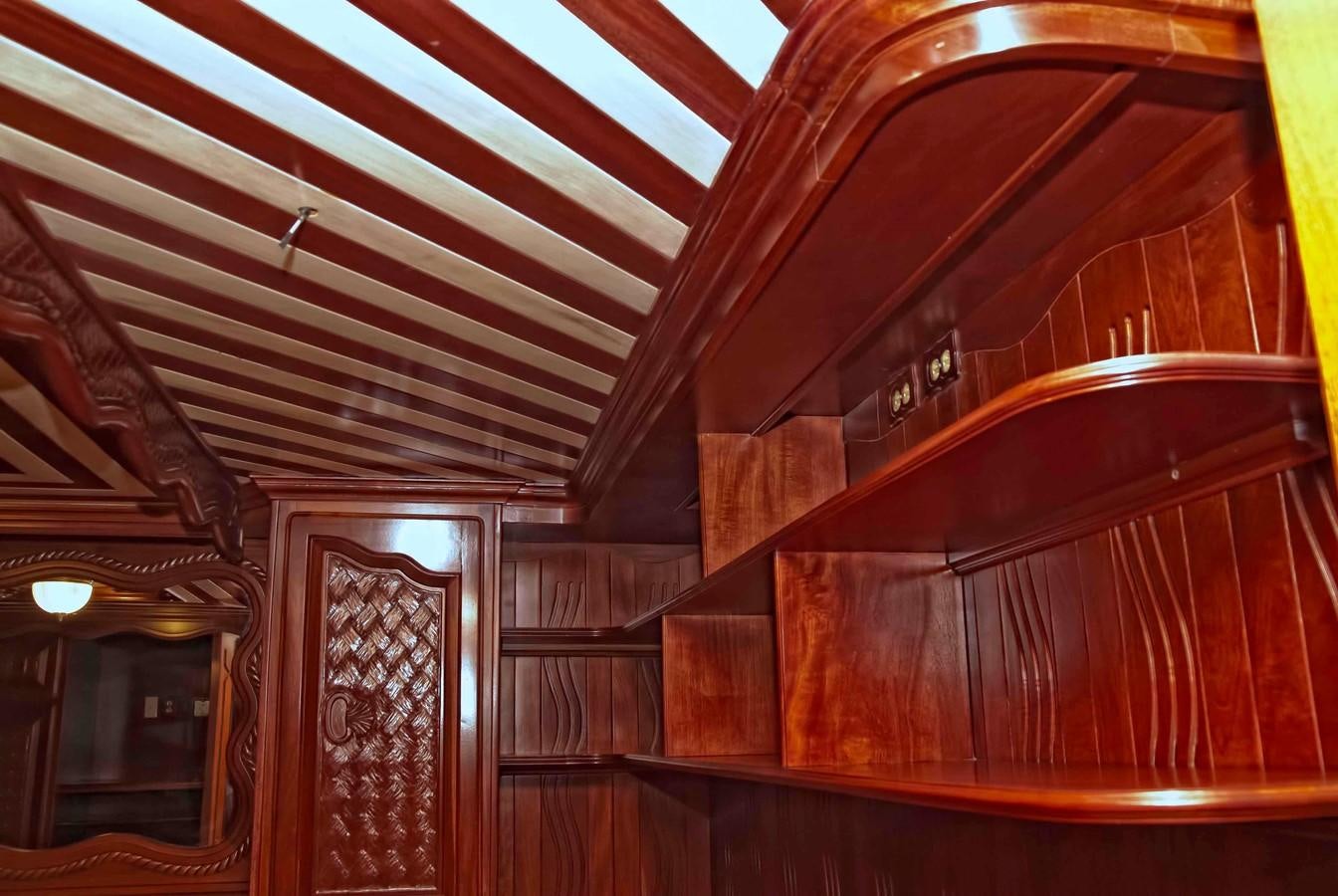 a wooden staircase with wood walls aboard PRINCIPE DEL MAR Yacht for Sale