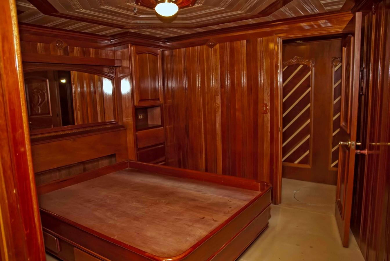 a room with a bed and a closet aboard PRINCIPE DEL MAR Yacht for Sale
